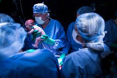Dr Gunby and Johannesson delivering the baby